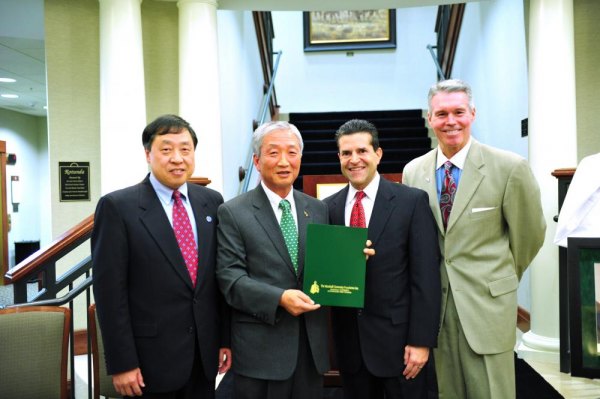 Dr. Chong W. Kim Endowed Scholarship honors two-time dean at Marshall From left, Dr. Haiyang Chen, Dr. Chong Kim, Norman Mosrie, and Lance West, pose with a copy of the guidelines for the Kim scholarship.